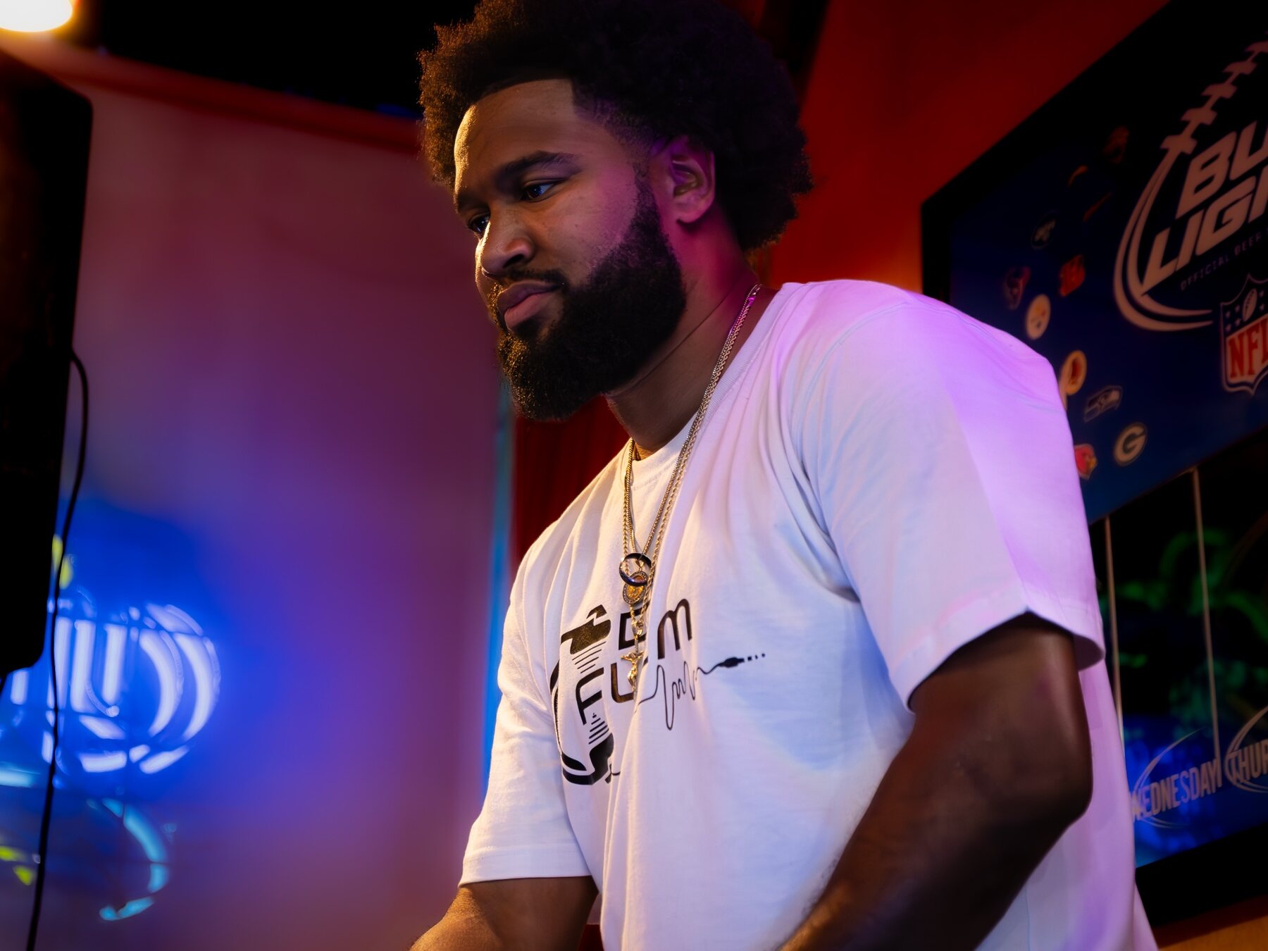 DJ Flem performing in a colorful studio