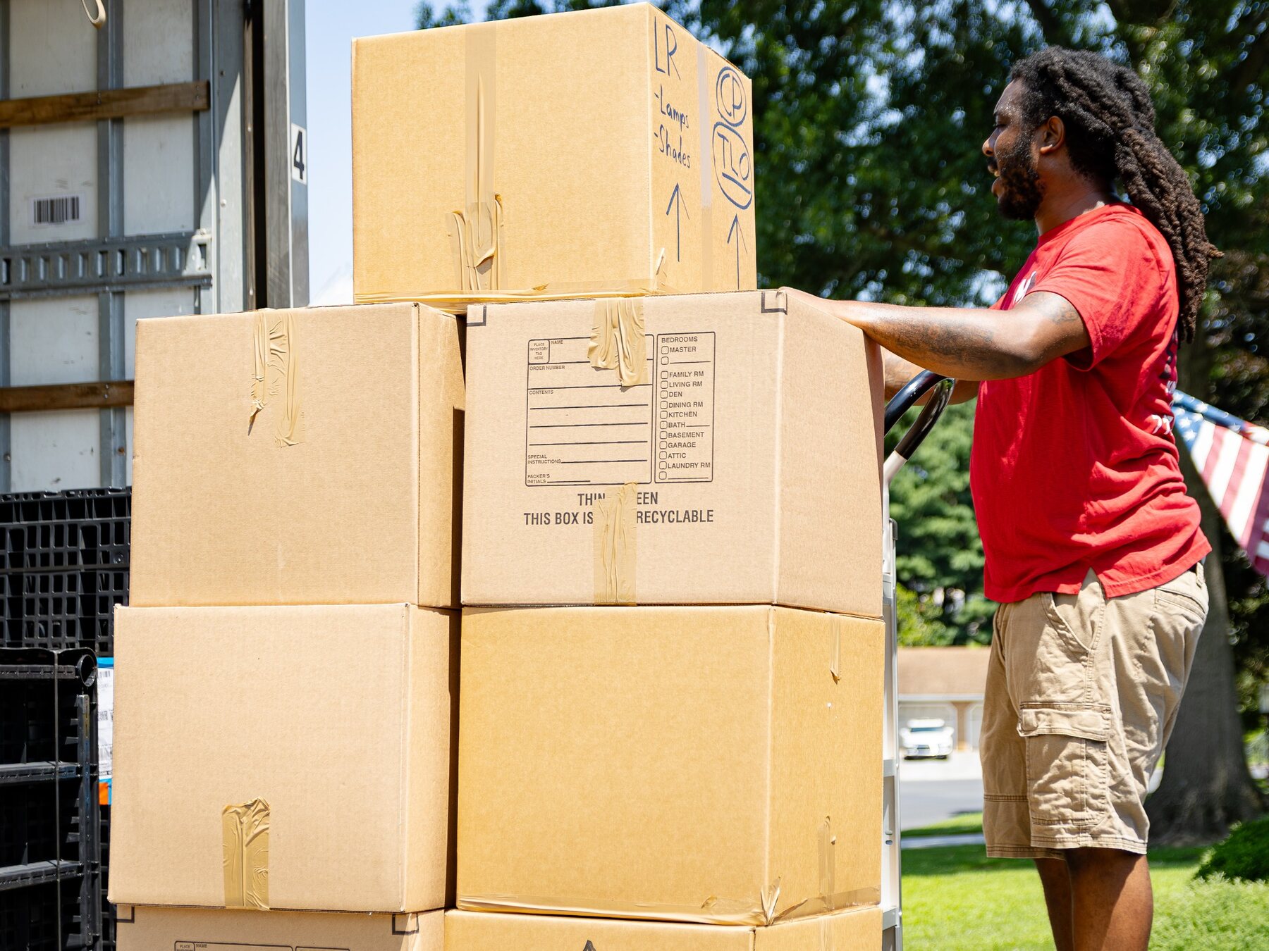 Making Moves team member moving packed boxes