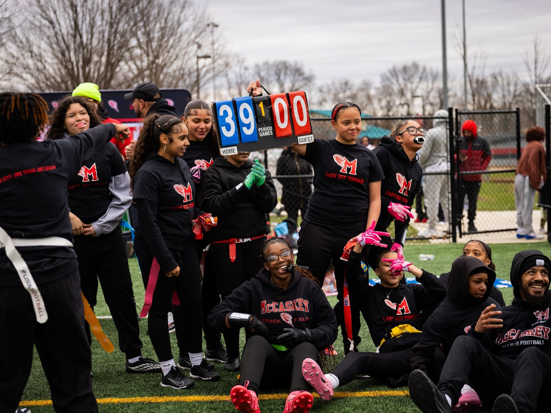 McCaskey girls flag football team celebrating together